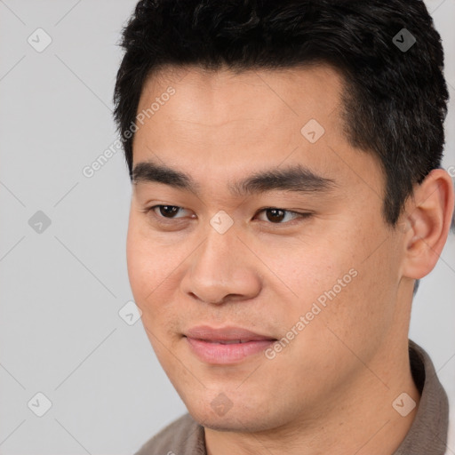 Joyful asian young-adult male with short  black hair and brown eyes