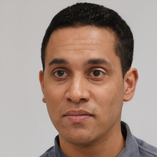 Neutral latino adult male with short  black hair and brown eyes