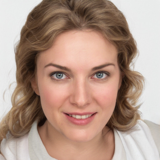 Joyful white young-adult female with medium  brown hair and blue eyes