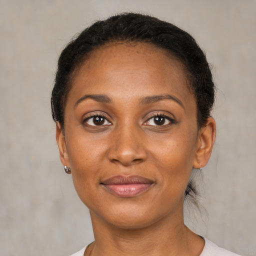 Joyful black adult female with short  brown hair and brown eyes