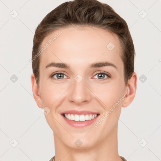 Joyful white young-adult female with short  brown hair and grey eyes