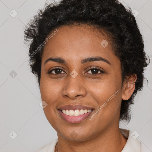 Joyful black young-adult female with short  brown hair and brown eyes