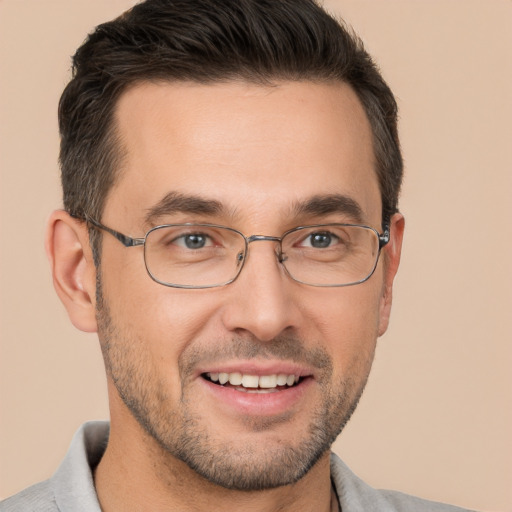 Joyful white adult male with short  brown hair and brown eyes