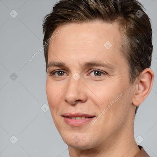 Joyful white adult male with short  brown hair and brown eyes