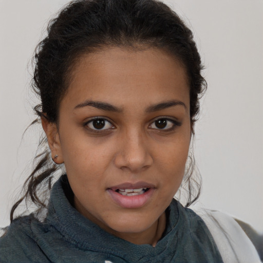 Joyful latino young-adult female with short  brown hair and brown eyes