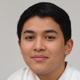 Joyful latino young-adult male with short  black hair and brown eyes