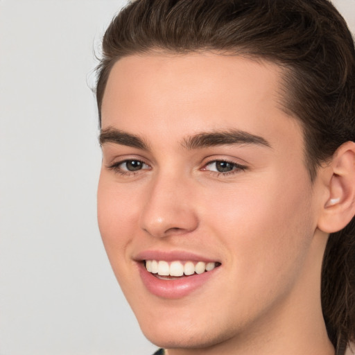 Joyful white young-adult male with medium  brown hair and brown eyes