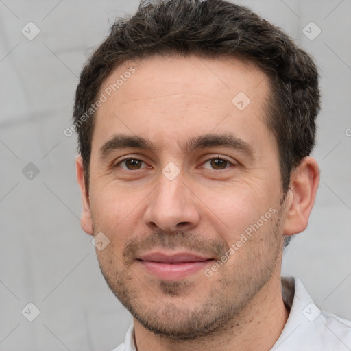 Joyful white adult male with short  brown hair and brown eyes