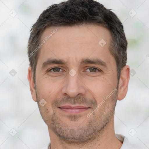 Joyful white adult male with short  brown hair and brown eyes