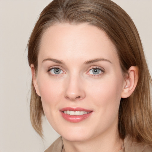 Joyful white young-adult female with long  brown hair and blue eyes