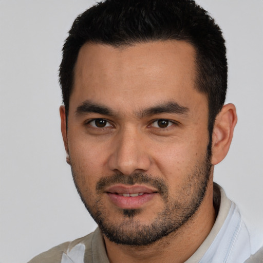 Joyful white young-adult male with short  black hair and brown eyes