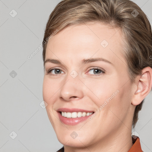 Joyful white young-adult female with short  brown hair and grey eyes