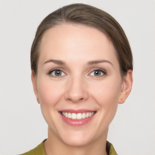 Joyful white young-adult female with short  brown hair and grey eyes