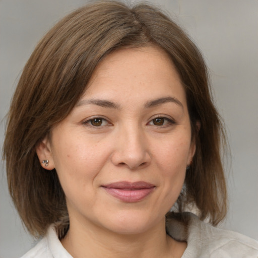 Joyful white adult female with medium  brown hair and brown eyes