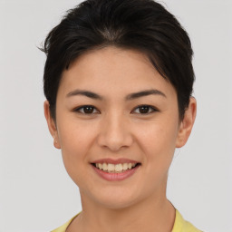 Joyful asian young-adult female with short  brown hair and brown eyes