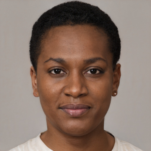 Joyful black young-adult female with short  black hair and brown eyes
