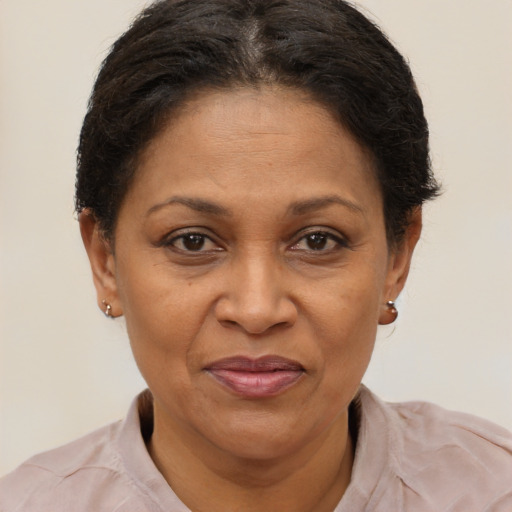Joyful black adult female with short  brown hair and brown eyes