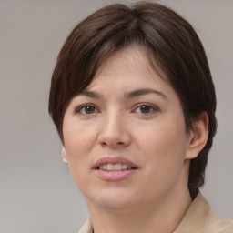 Joyful white young-adult female with medium  brown hair and brown eyes