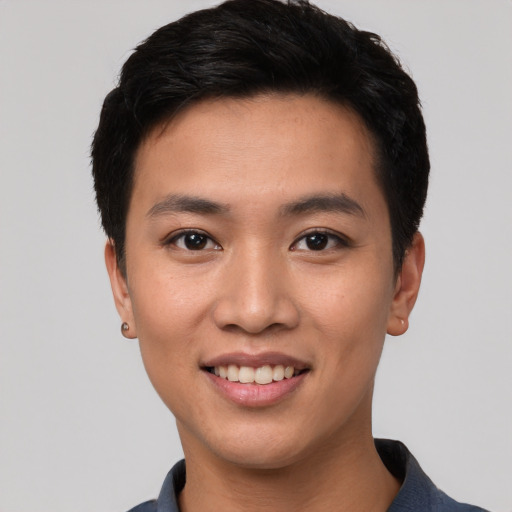 Joyful asian young-adult male with short  black hair and brown eyes