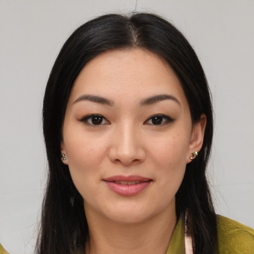 Joyful asian young-adult female with long  brown hair and brown eyes