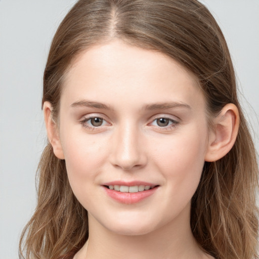 Joyful white young-adult female with long  brown hair and grey eyes