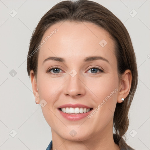 Joyful white young-adult female with medium  brown hair and grey eyes