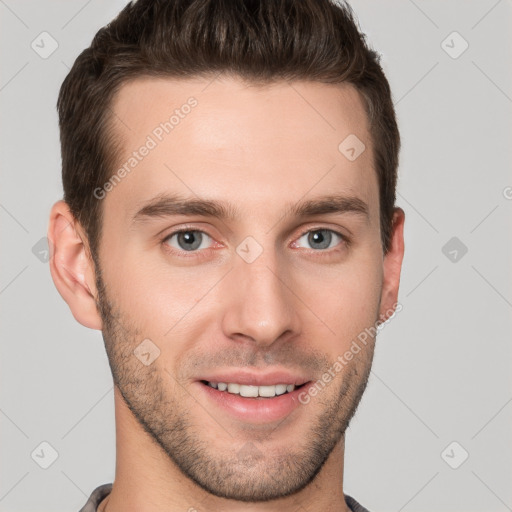 Joyful white young-adult male with short  brown hair and grey eyes