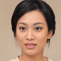 Joyful asian young-adult female with medium  black hair and brown eyes