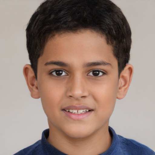 Joyful latino child male with short  brown hair and brown eyes