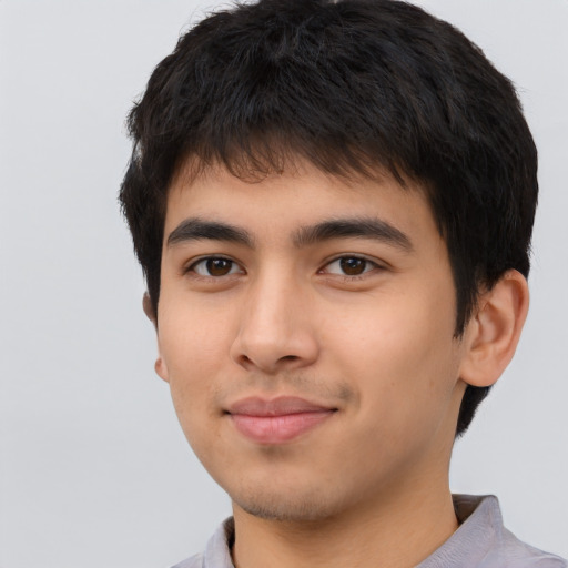 Joyful asian young-adult male with short  brown hair and brown eyes