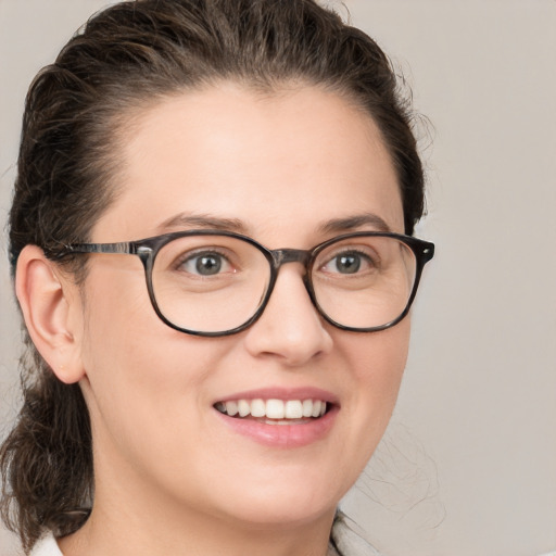 Joyful white young-adult female with medium  brown hair and grey eyes