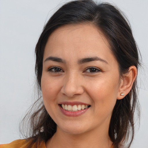 Joyful white young-adult female with long  brown hair and brown eyes