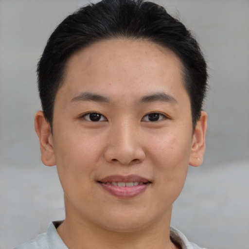 Joyful asian young-adult male with short  brown hair and brown eyes