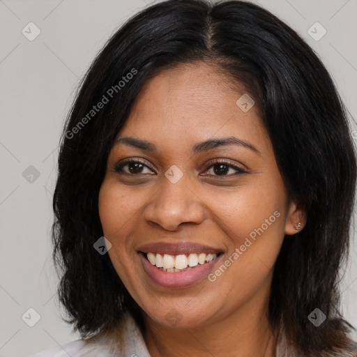 Joyful black young-adult female with long  brown hair and brown eyes