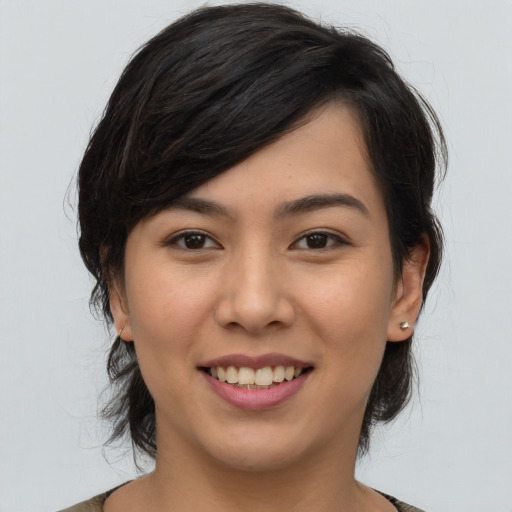 Joyful asian young-adult female with medium  brown hair and brown eyes