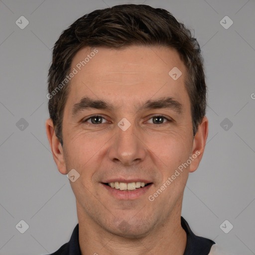 Joyful white young-adult male with short  brown hair and brown eyes