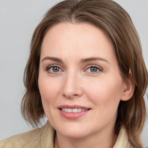 Joyful white young-adult female with medium  brown hair and grey eyes