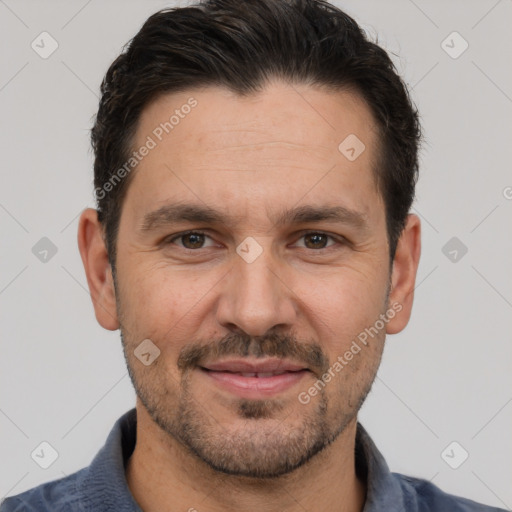 Joyful white adult male with short  brown hair and brown eyes