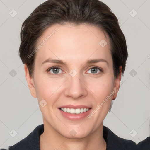 Joyful white adult female with short  brown hair and grey eyes