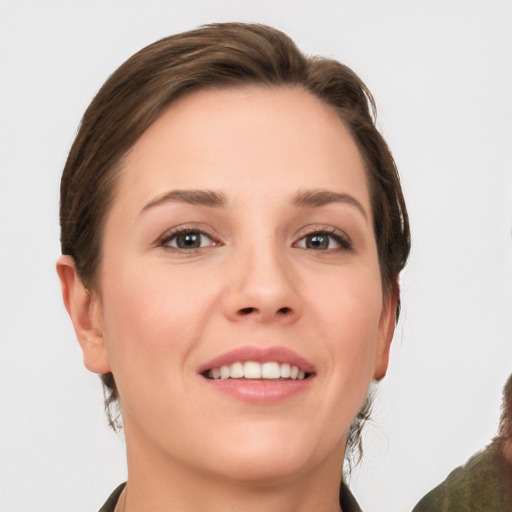 Joyful white young-adult female with medium  brown hair and grey eyes