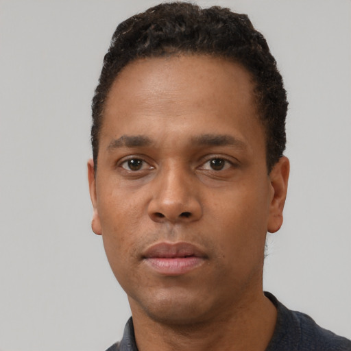 Neutral black young-adult male with short  black hair and brown eyes