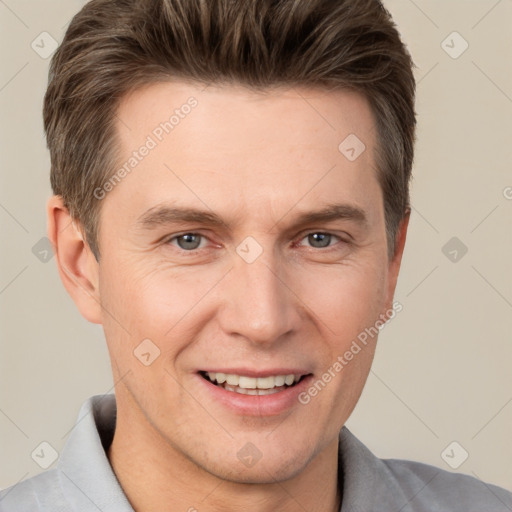 Joyful white adult male with short  brown hair and brown eyes