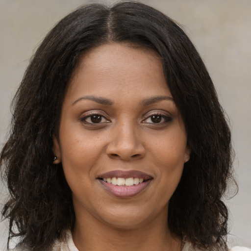 Joyful black young-adult female with medium  brown hair and brown eyes