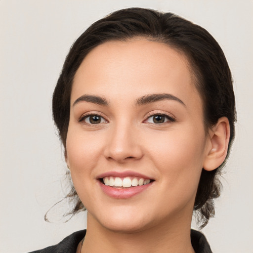 Joyful white young-adult female with medium  brown hair and brown eyes