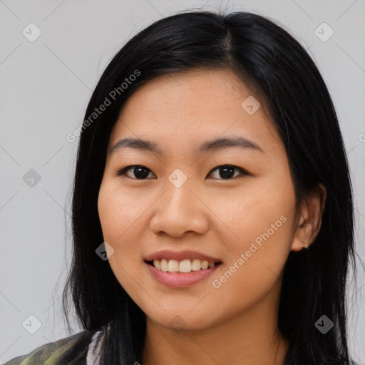 Joyful asian young-adult female with long  black hair and brown eyes