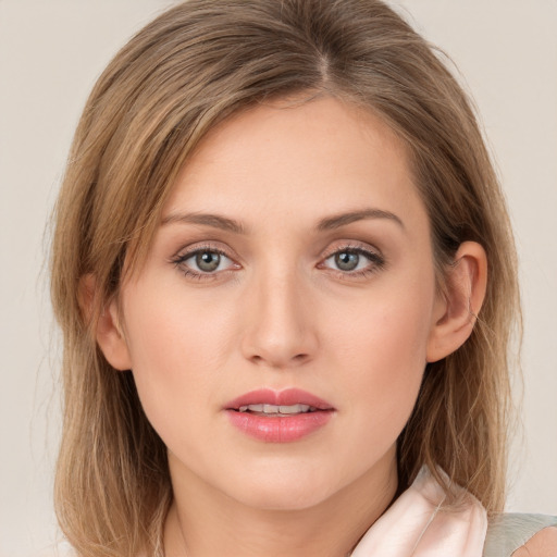 Joyful white young-adult female with medium  brown hair and green eyes