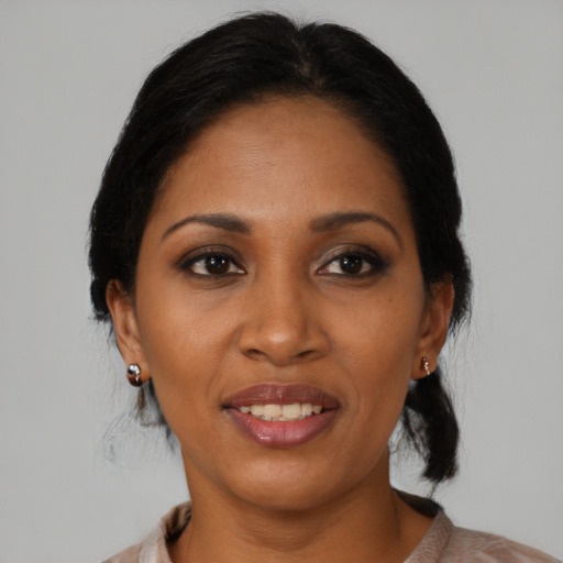 Joyful black young-adult female with medium  brown hair and brown eyes