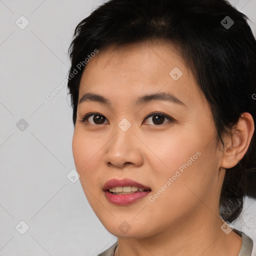 Joyful asian young-adult female with short  black hair and brown eyes