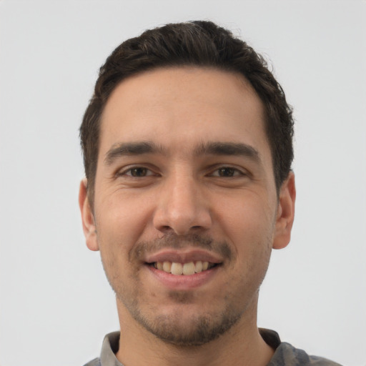 Joyful white young-adult male with short  brown hair and brown eyes