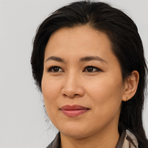 Joyful asian young-adult female with long  brown hair and brown eyes